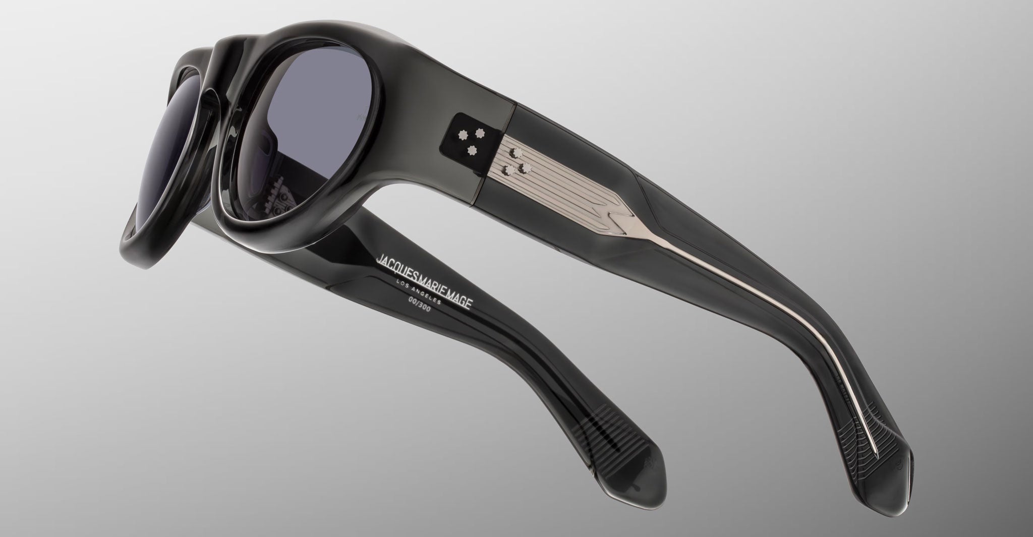 Side view of the Jacques Marie Mage Clyde 2.0 sunglass in Grisaille Black acetate wtih silver in the temples and dark lenses