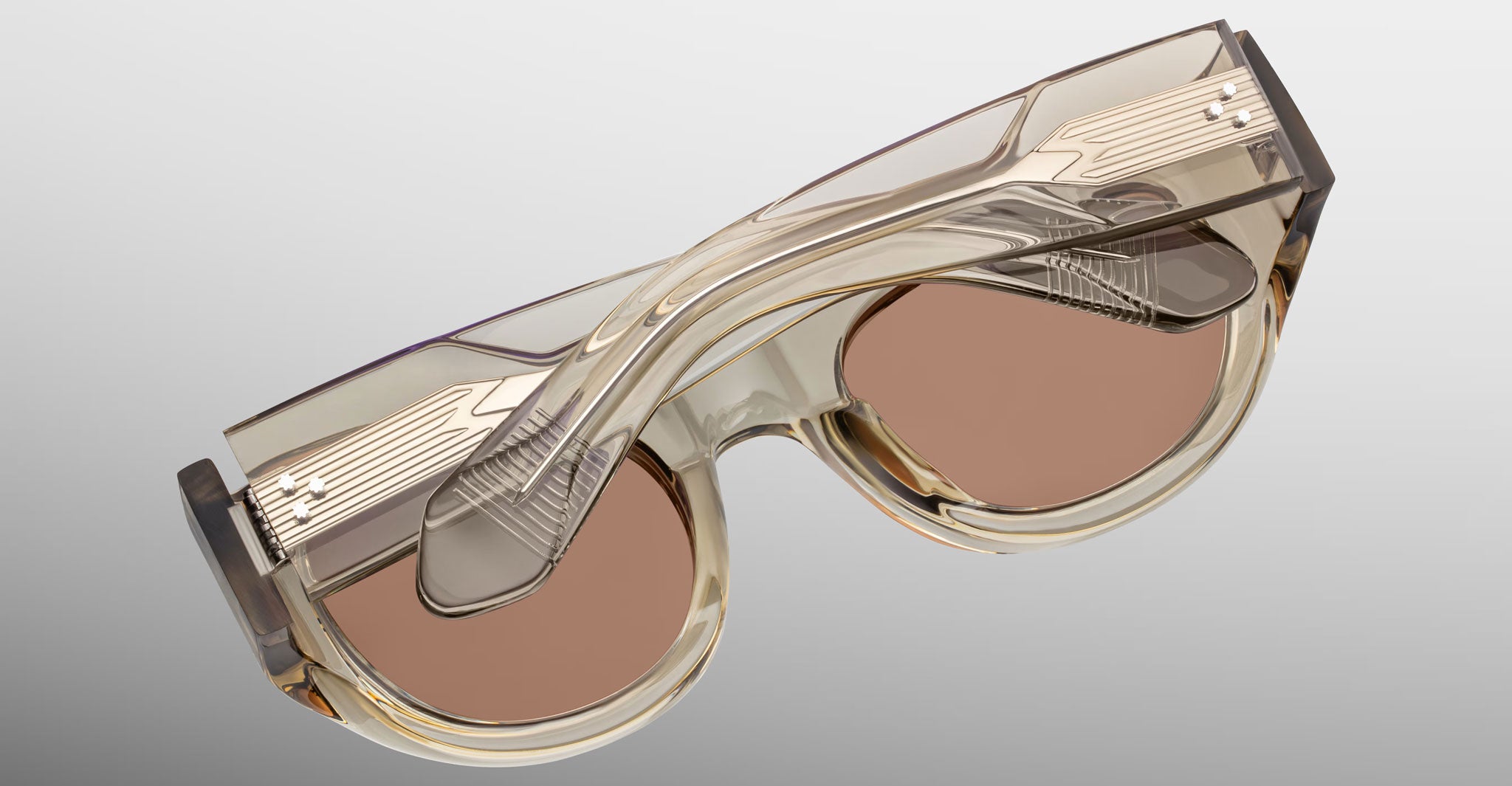 Back detailed view of the Jacques Marie Mage Clyde 2.0 sunglass in Marzipan translucent tan acetate on a light gray background