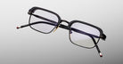 Jacques Marie Mage Comanche in Corbeau black rectangular eyeglasses with thin frames and clear lenses, front view.