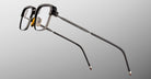 Jacques Marie Mage Comanche in Corbeau black rectangular eyeglasses with metal arms and nose pads, profile view.