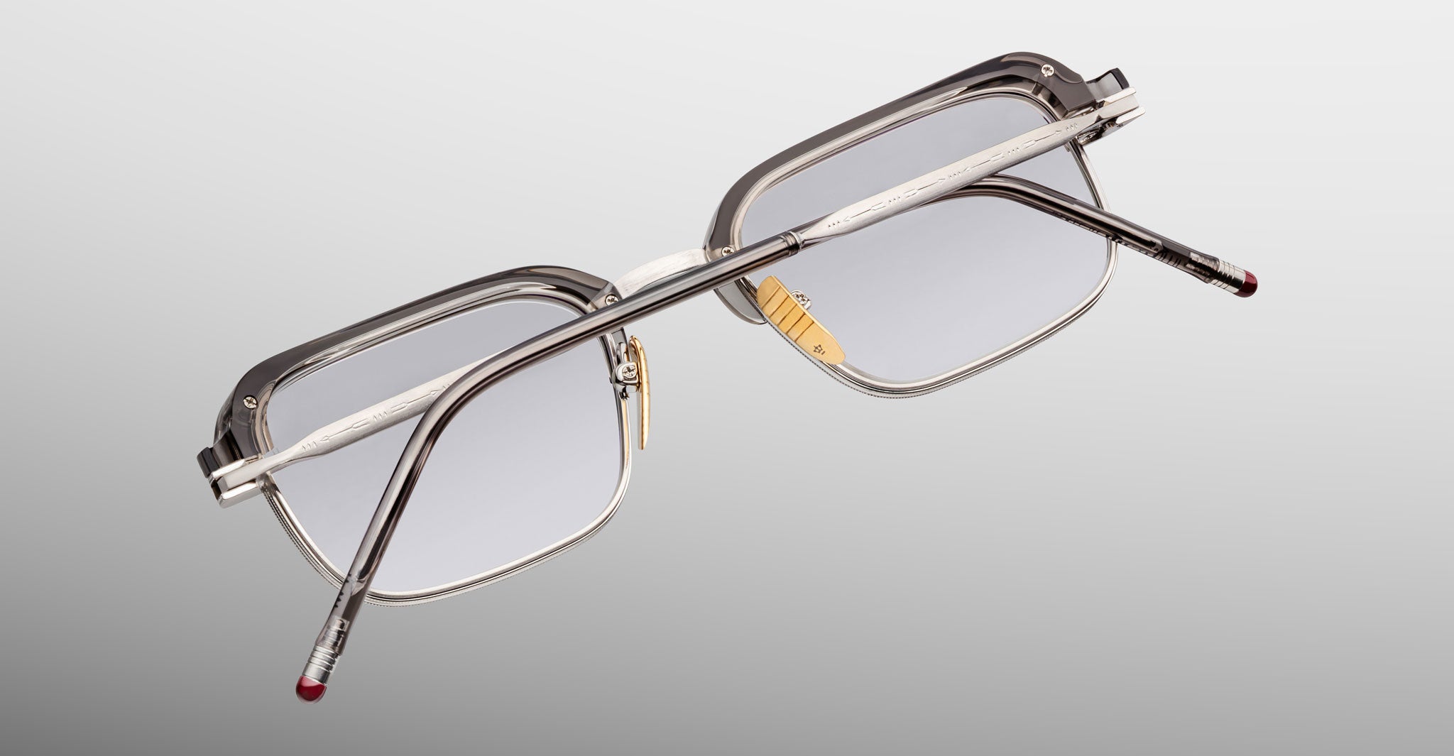 Jacques Marie Mage Comanche in Tempest rectangular eyeglasses with clear frames and silver arms, viewed from the back.