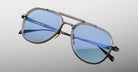 Three-quarter view of Jacques Marie Mage Commander in Antique Silver, showcasing the antique silver-tone double-bridge frame, engraved aviator rims, and cool blue lenses with a crisp, refined finish.