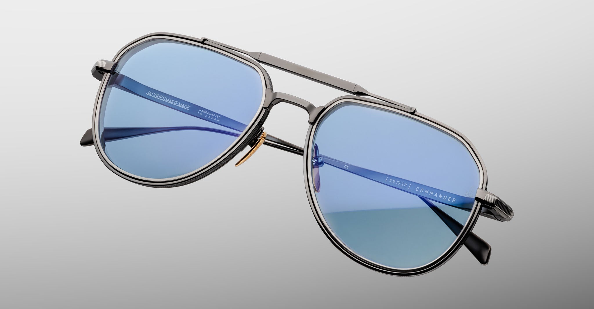 Three-quarter view of Jacques Marie Mage Commander in Antique Silver, showcasing the antique silver-tone double-bridge frame, engraved aviator rims, and cool blue lenses with a crisp, refined finish.