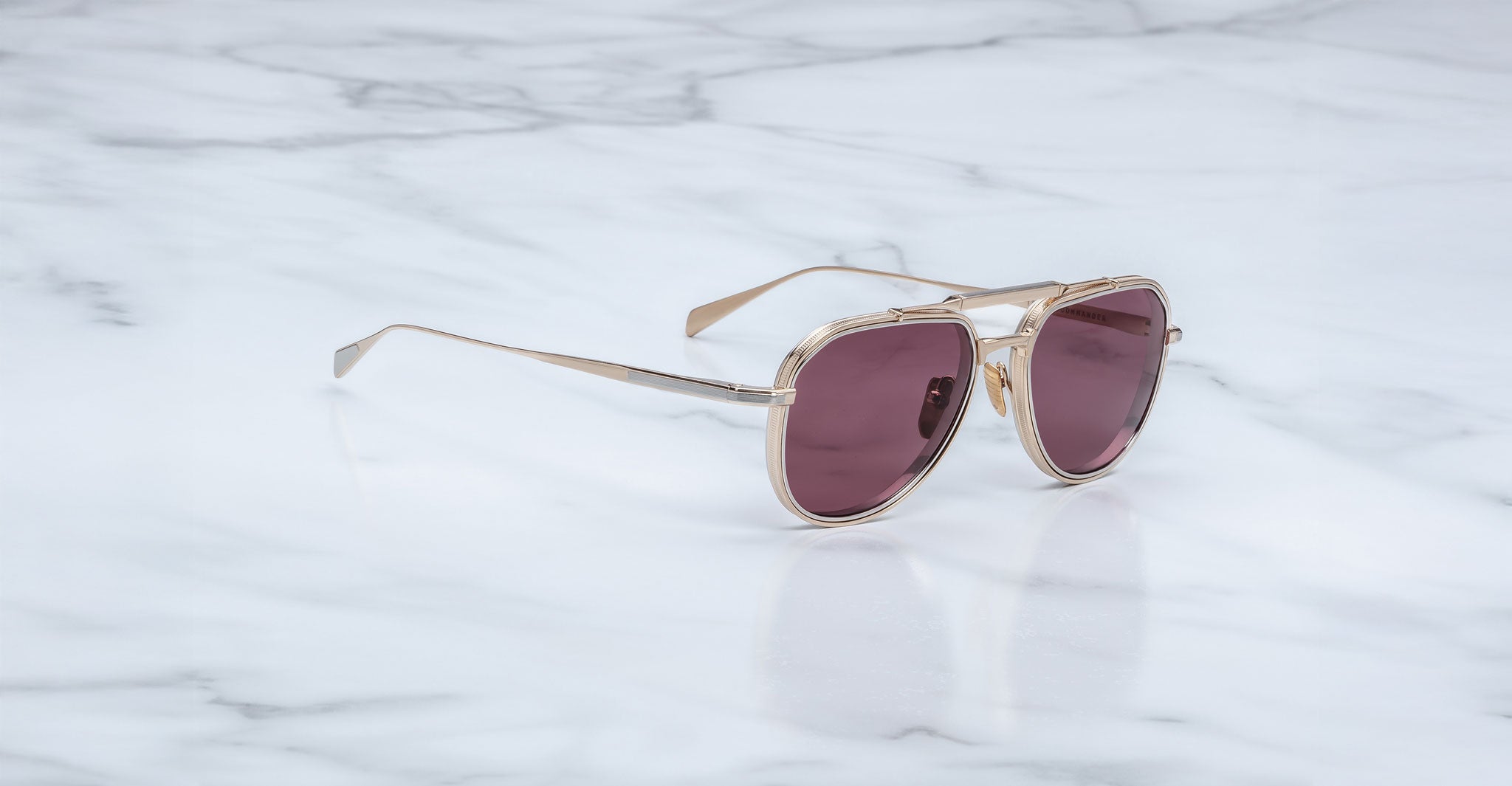Jacques Marie Mage Commander in Champagne, angled view featuring a light gold-tone titanium aviator frame with double bridge, engraved rims, and softly tinted rose-champagne lenses.
