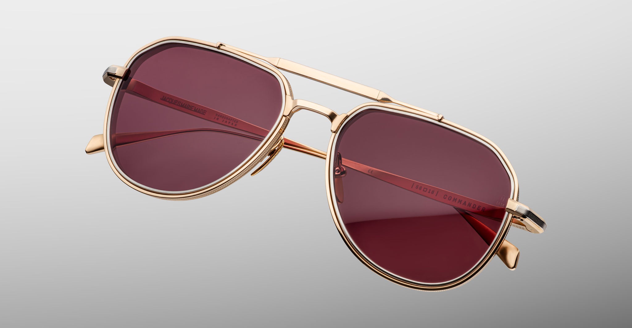 Three-quarter view of Jacques Marie Mage Commander in Champagne, showcasing the light gold-tone double-bridge frame, engraved aviator rims, and rose-champagne lenses with a warm, refined glow.