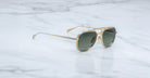Jacques Marie Mage Commander in Musket — gold-tone aviator sunglasses with a double-bridge titanium frame, green lenses, and slim sculpted temples.
