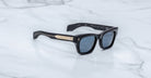 Jacques Marie Mage Dealan 53 black polarized sunglasses with gold temples, top view.