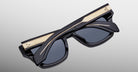 Jacques Marie Mage Dealan 53 sunglasses with gold accents, folded, viewed from above.