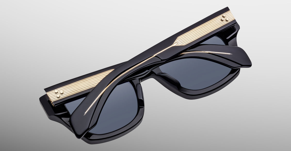 Jacques Marie Mage Dealan 53 sunglasses with gold accents, folded, viewed from above.