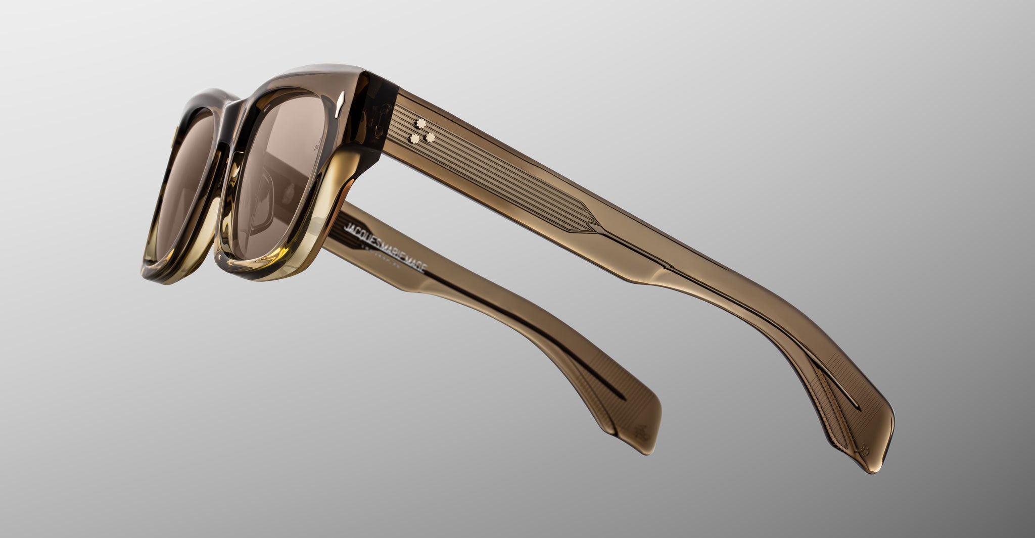 Jacques Marie Mage Dealan 53 sunglasses shown front view, brown translucent thick angular retro-style frame.
