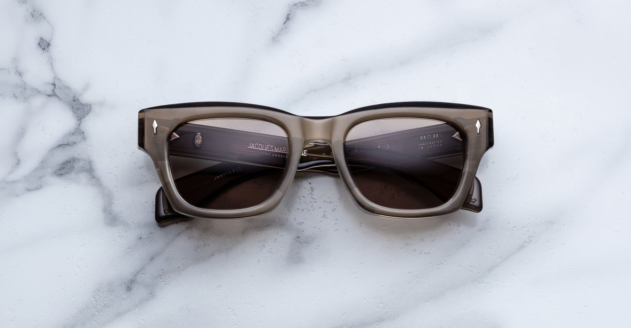 Jacques Marie Mage Dealan 53 sunglasses, black and gray with dark lenses, shown from above.