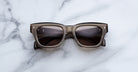 Jacques Marie Mage Dealan 53 sunglasses, black and gray with dark lenses, shown from above.