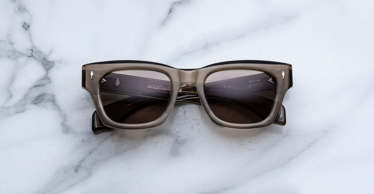 Jacques Marie Mage Dealan 53 sunglasses, black and gray with dark lenses, shown from above.