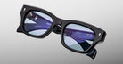 Jacques Marie Mage Dealan 53 eyeglasses, black rectangular frame with blue-tinted lenses, front view.