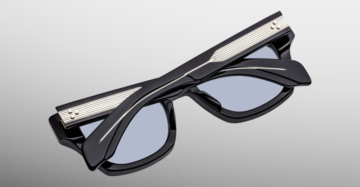 Jacques Marie Mage Dealan 53 black polarized sunglasses with silver accents, folded, top view.
