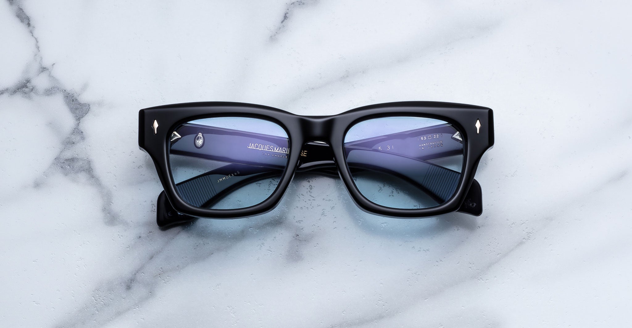 Jacques Marie Mage Dealan 53 black rectangular eyeglasses with clear lenses, top-down view.