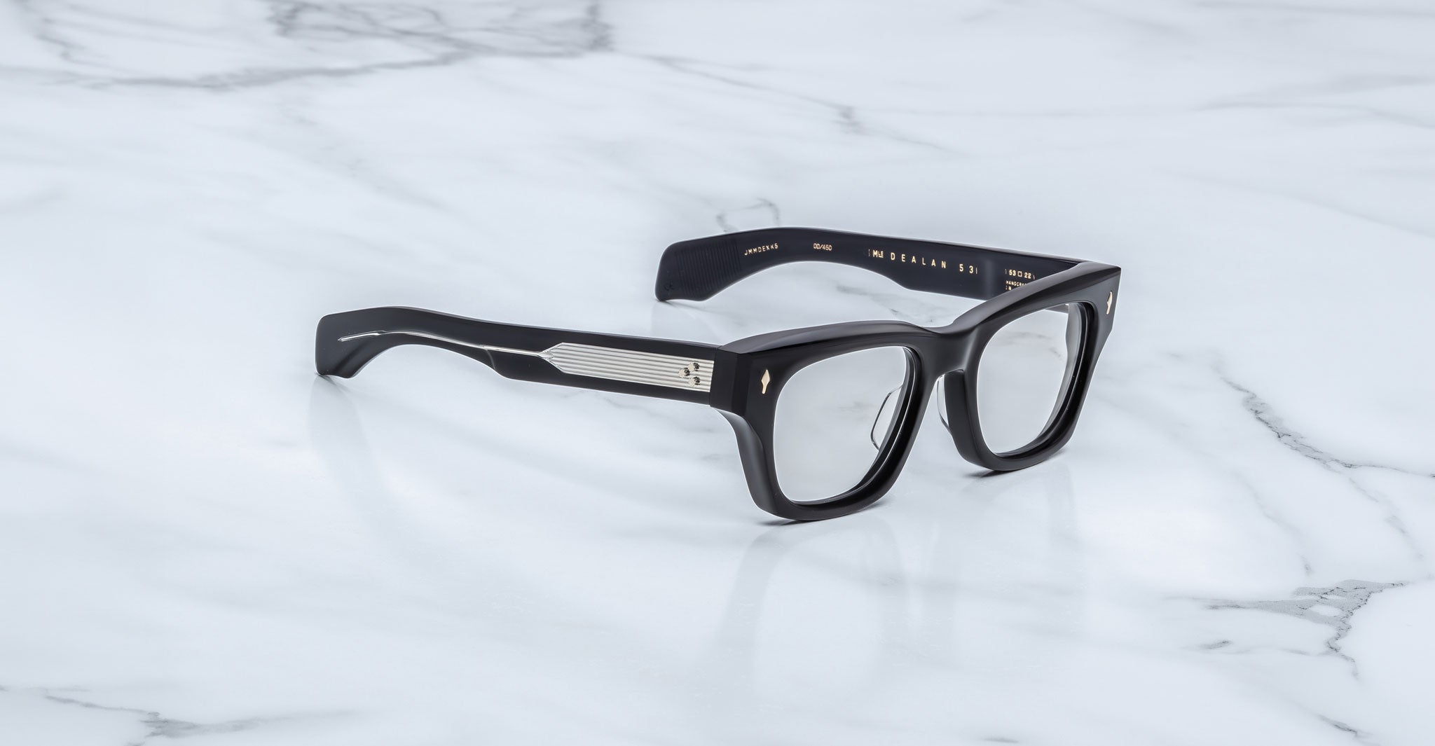 Jacques Marie Mage Dealan 53 eyeglasses, black thick rectangular frames with silver temples, shown from above.