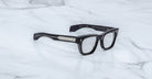 Jacques Marie Mage Dealan 53 eyeglasses, black thick rectangular frames with silver temples, shown from above.