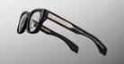 Jacques Marie Mage Dealan 53 black eyeglasses with gold accents and branding, front view.