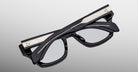 Jacques Marie Mage Dealan 53 black eyeglasses with silver temple accents, top view.
