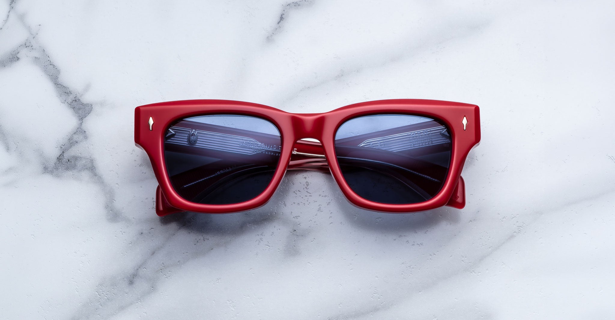 Jacques Marie Mage Dealan 53 red sunglasses with UV-protected dark lenses, top view.