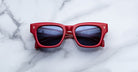 Jacques Marie Mage Dealan 53 red sunglasses with UV-protected dark lenses, top view.