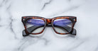 Jacques Marie Mage Dealan rectangular eyeglasses with clear lenses, viewed from above.