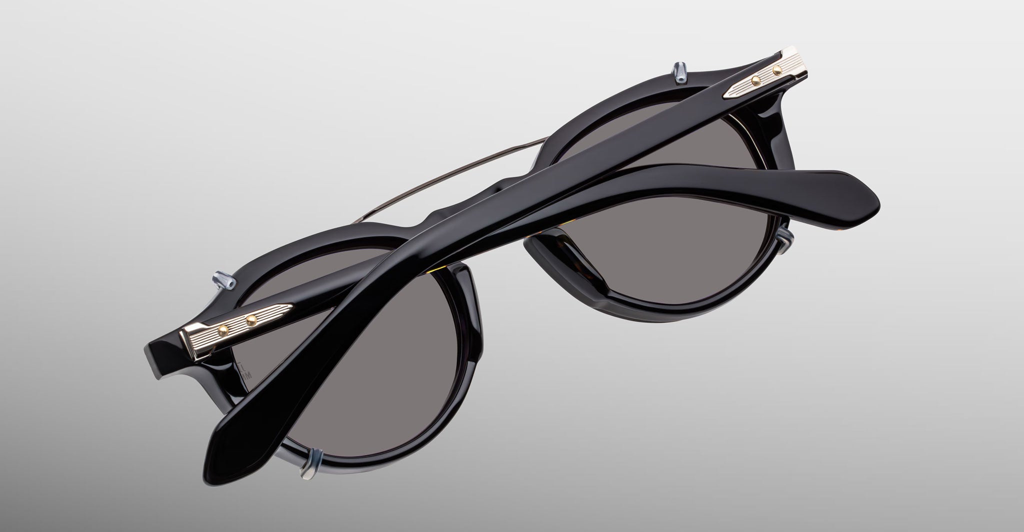 Jacques Marie Mage Demoncey Clip-On sunglasses, gold accents, folded view. Brand and model clearly visible.