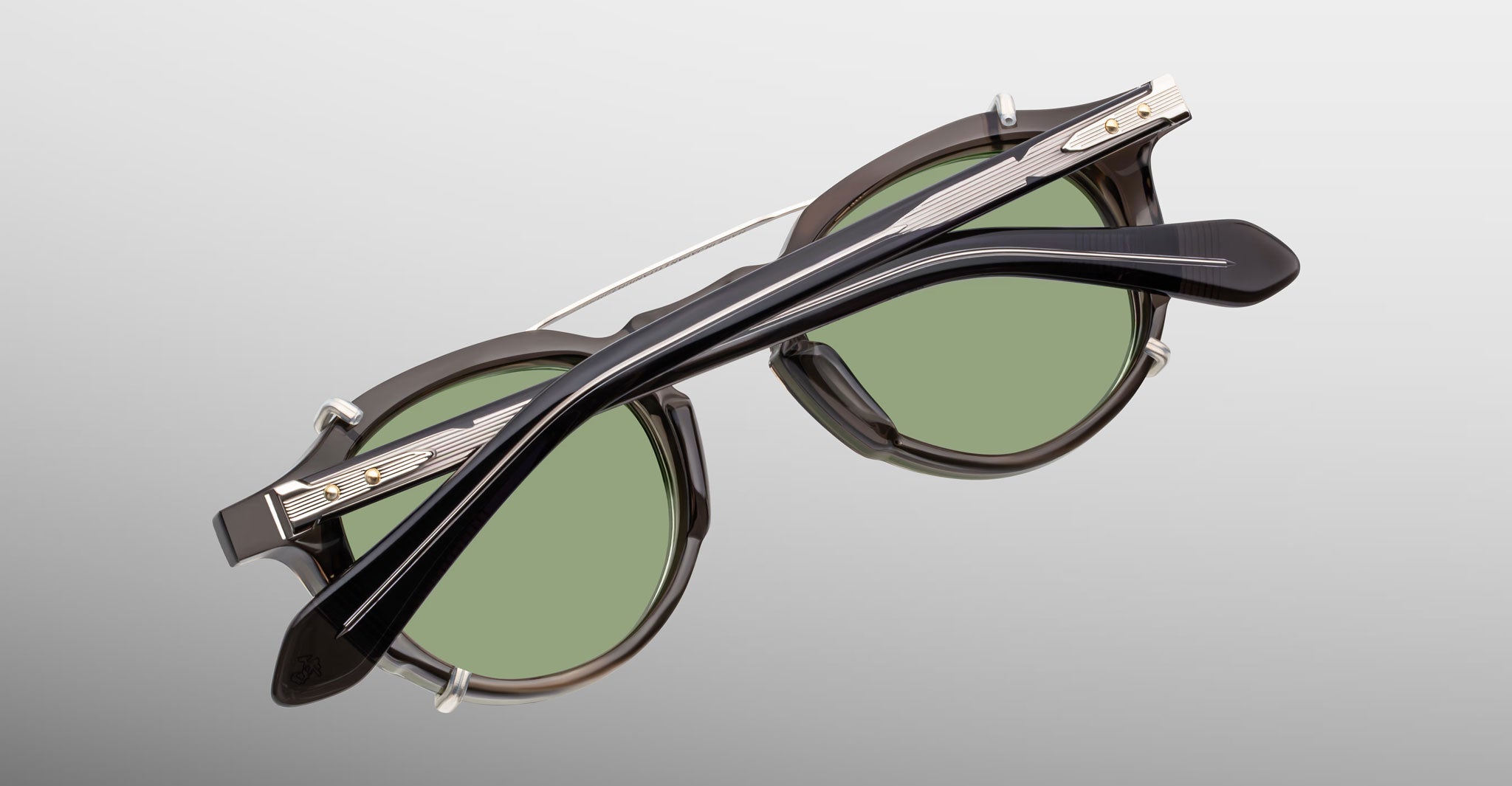 Jacques Marie Mage Demoncey Clip-On round sunglasses with green lenses and black frames, front view.