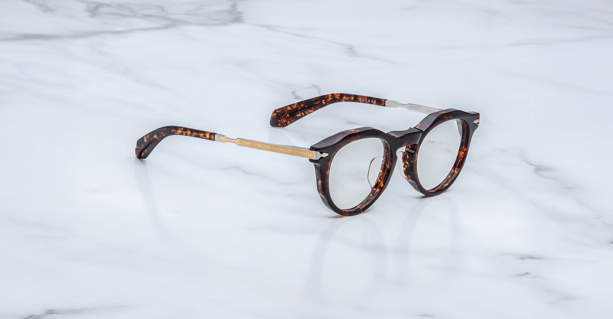 Jacques Marie Mage Desnos round tortoiseshell eyeglasses with gold arms, top view.