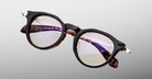 Jacques Marie Mage Desnos round tortoiseshell eyeglasses with clear lenses and silver hinges, front view.