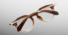 Jacques Marie Mage Desnos eyeglasses with brown and gold frames, decorative temples, shown from the front.