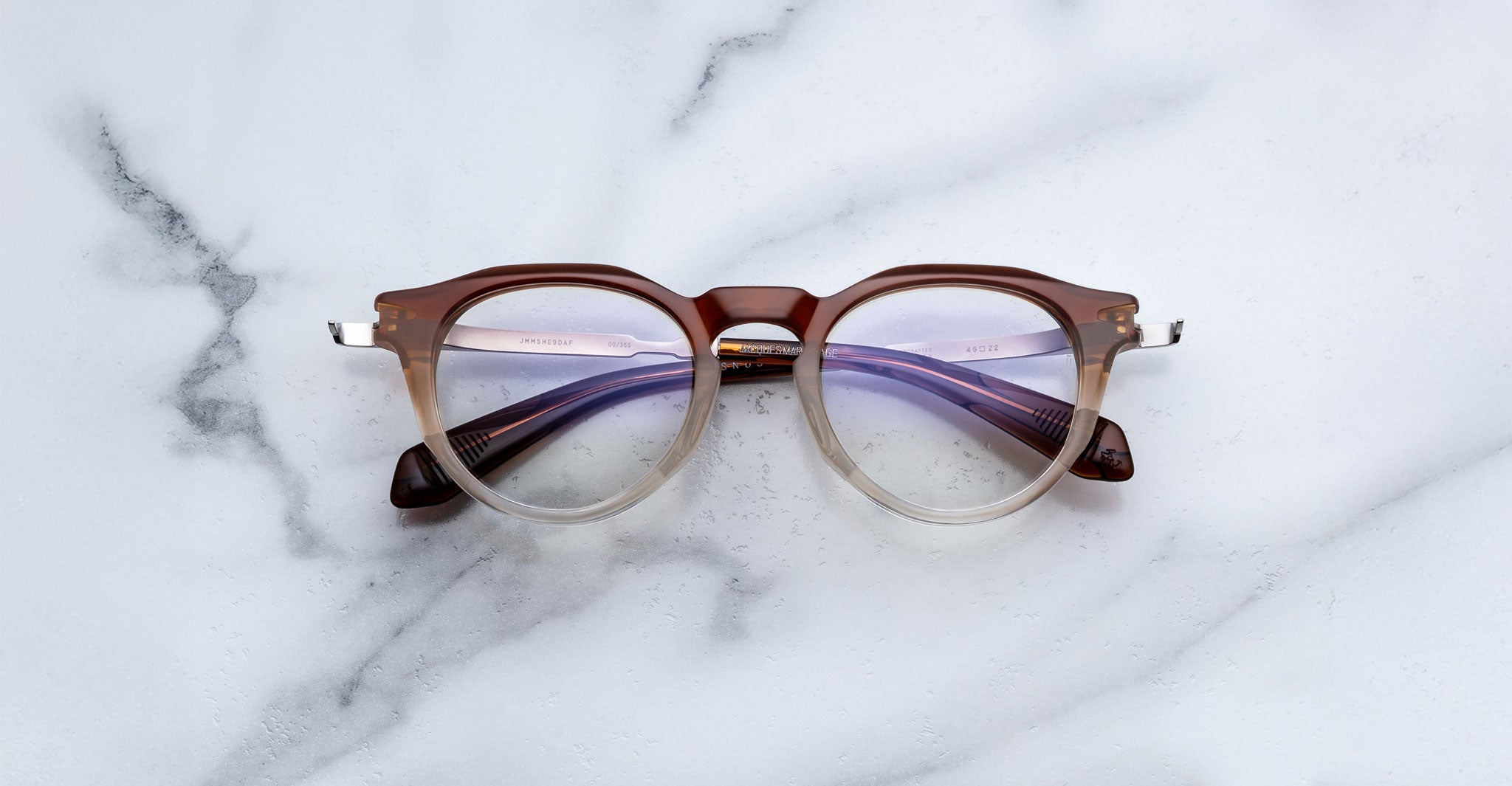 Jacques Marie Mage Desnos round eyeglasses with brown frames and clear lenses, front view.