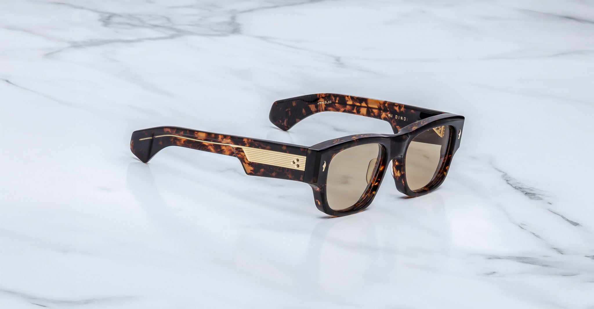 Jacques Marie Mage Dino in Agar tortoiseshell acetate sunglass frame with brown lenses, gold arrowhead pins, and sculptural wide temples