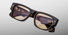 Jacques Marie Mage Dino in Agar tortoiseshell acetate sunglass frame with brown lenses, gold arrowhead pins, and sculptural wide temples, angled top view showing lens and bridge detail