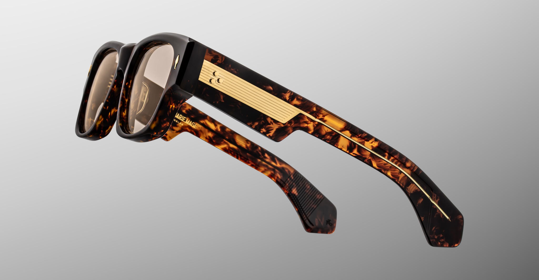 Jacques Marie Mage Dino in Agar tortoiseshell acetate sunglass frame with brown lenses, gold arrowhead pins, and sculptural wide temples, side view showing engraved wirecore and temple detail