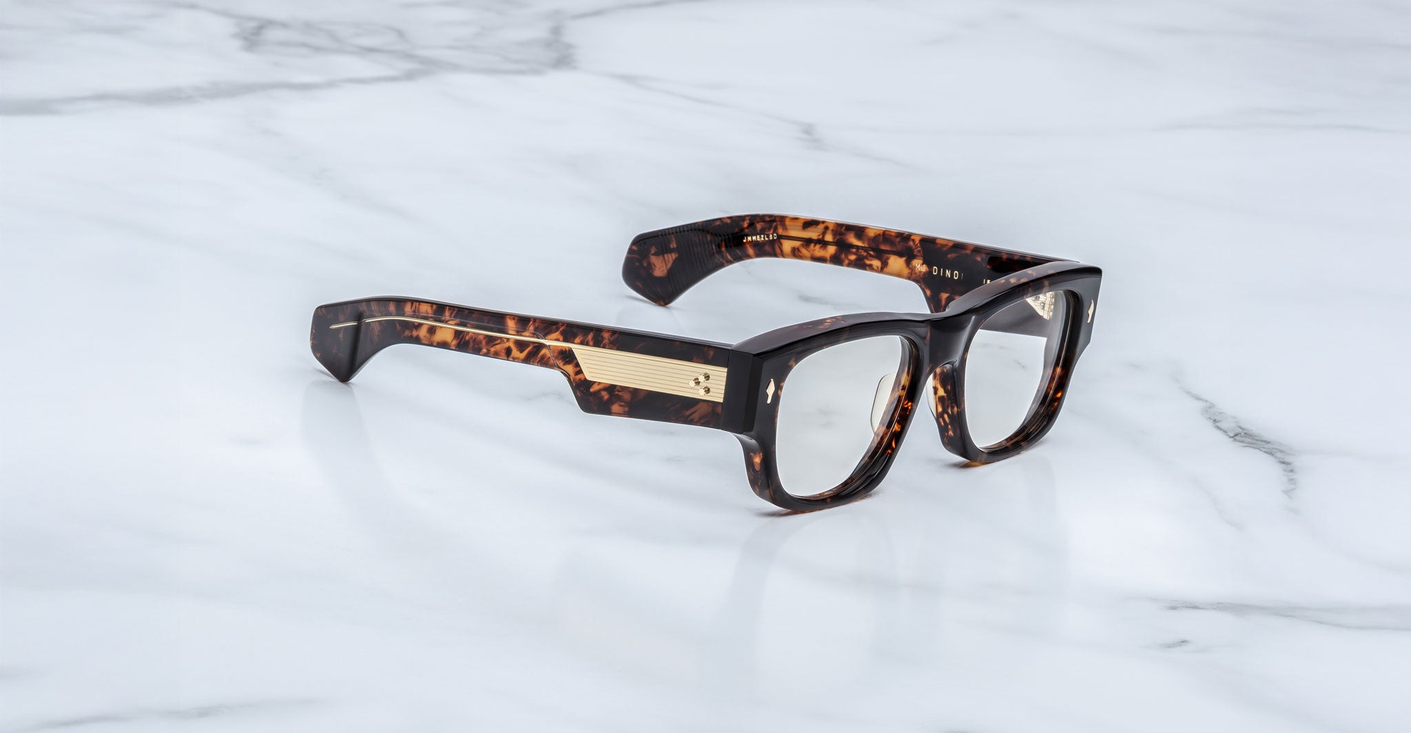 Jacques Marie Mage Dino in Agar tortoiseshell acetate sunglass frame with superlight bronze lenses, gold arrowhead pins, and sculptural wide temples, side view showing engraved wirecore and temple detail