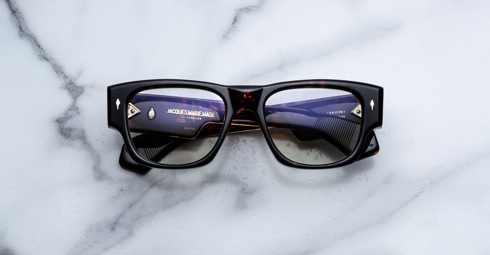 Jacques Marie Mage Dino in Agar tortoiseshell acetate sunglass frame with superlight bronze lenses, gold arrowhead pins, and sculptural wide temples