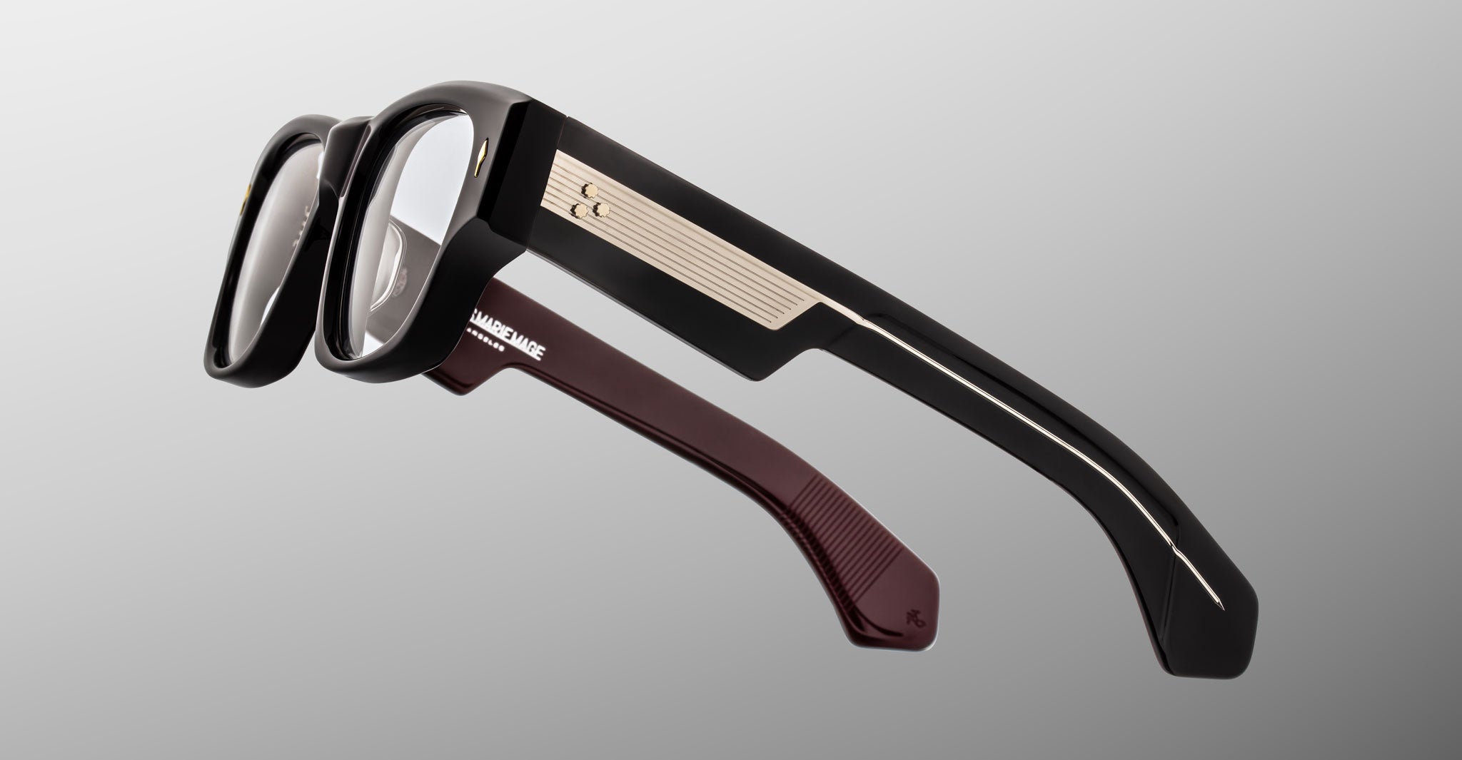 Jacques Marie Mage Dino in Bloodstone acetate optical frame with clear lenses, gold arrowhead pins, and sculptural wide temples, side view showing engraved wirecore and temple detail