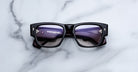 Jacques Marie Mage Dino in Bloodstone black acetate optical frame with clear lenses, gold arrowhead pins, and sculptural wide temples, front view