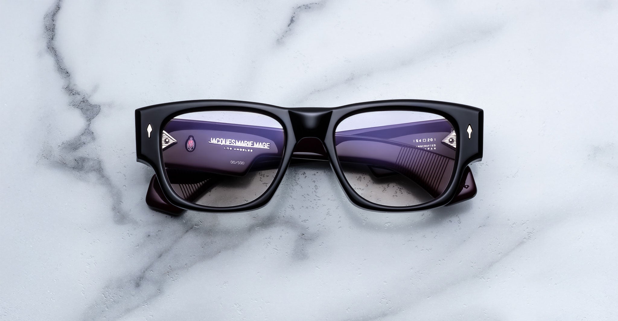 Jacques Marie Mage Dino in Bloodstone black acetate optical frame with clear lenses, gold arrowhead pins, and sculptural wide temples, front view