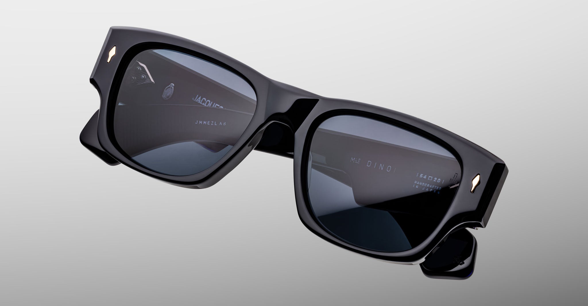 Jacques Marie Mage Dino in Lacquer dark blue acetate sunglass frame with lacquer dark blue lenses, gold arrowhead pins, and sculptural wide temples, angled top view showing lens and bridge detail