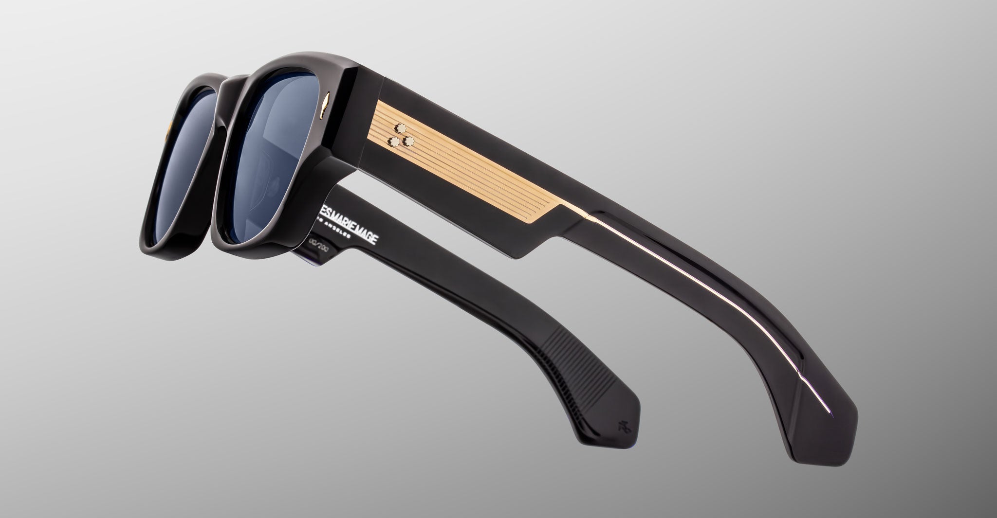 Jacques Marie Mage Dino in Lacquer dark blue acetate sunglass frame with lacquer dark blue lenses, gold arrowhead pins, and sculptural wide temples, side view showing engraved wirecore and temple detail