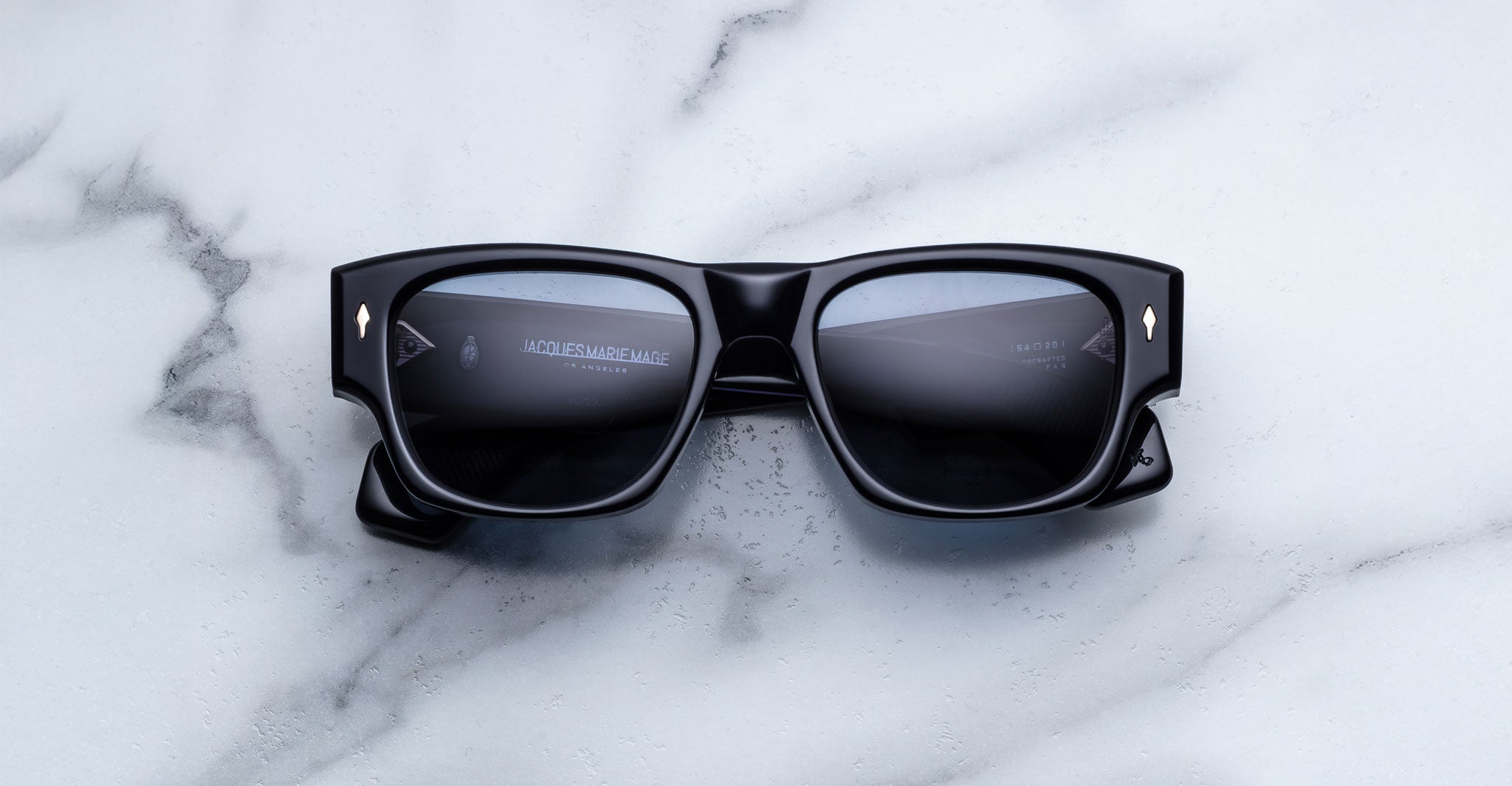 Jacques Marie Mage Dino in Lacquer dark blue acetate sunglass frame with lacquer dark blue lenses, gold arrowhead pins, and sculptural wide temples, front view