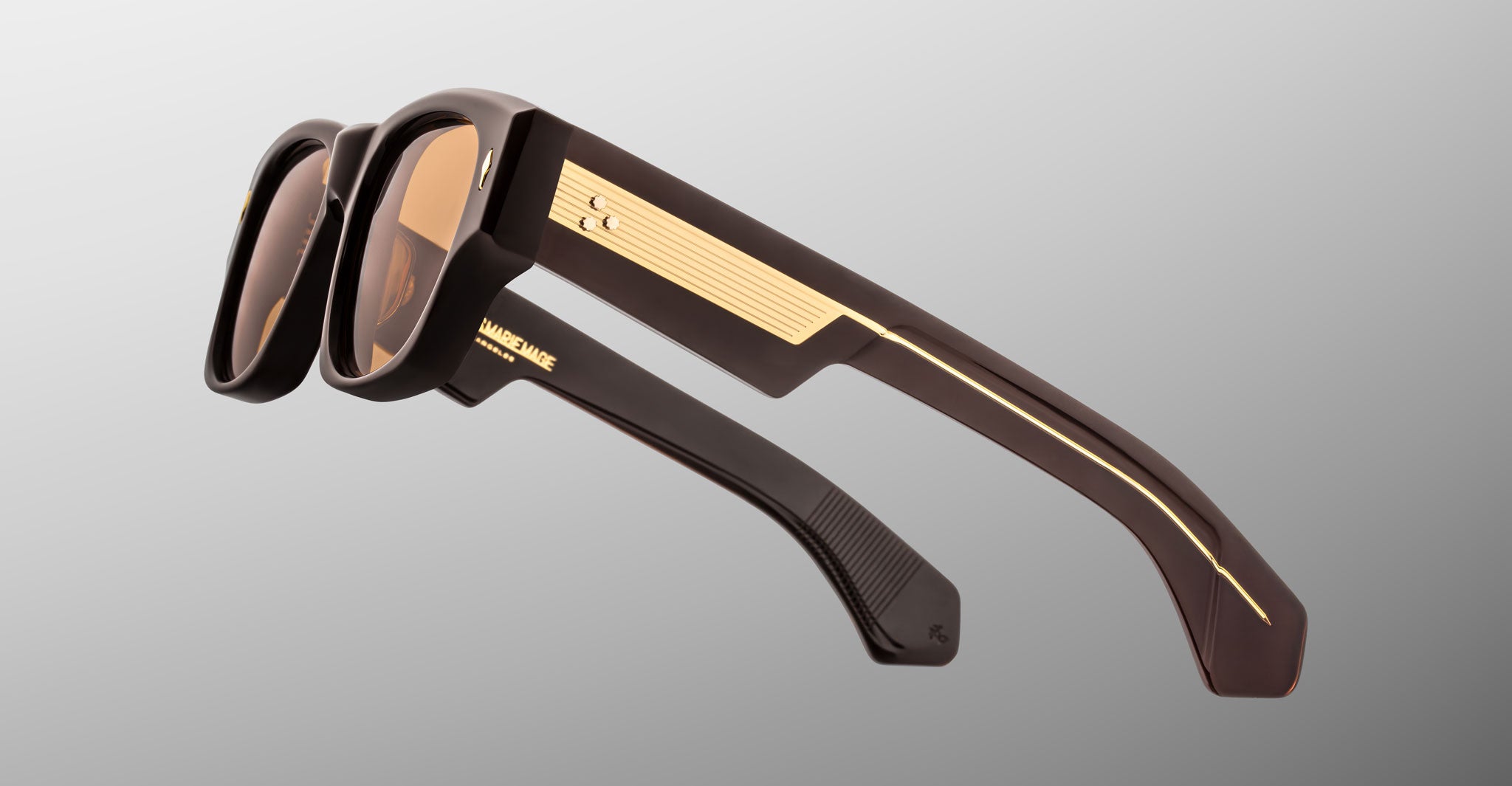 Jacques Marie Mage Dino in Walnut brown acetate sunglass frame with brown lenses, gold arrowhead pins, and sculptural wide temples, side view showing engraved wirecore and temple detail