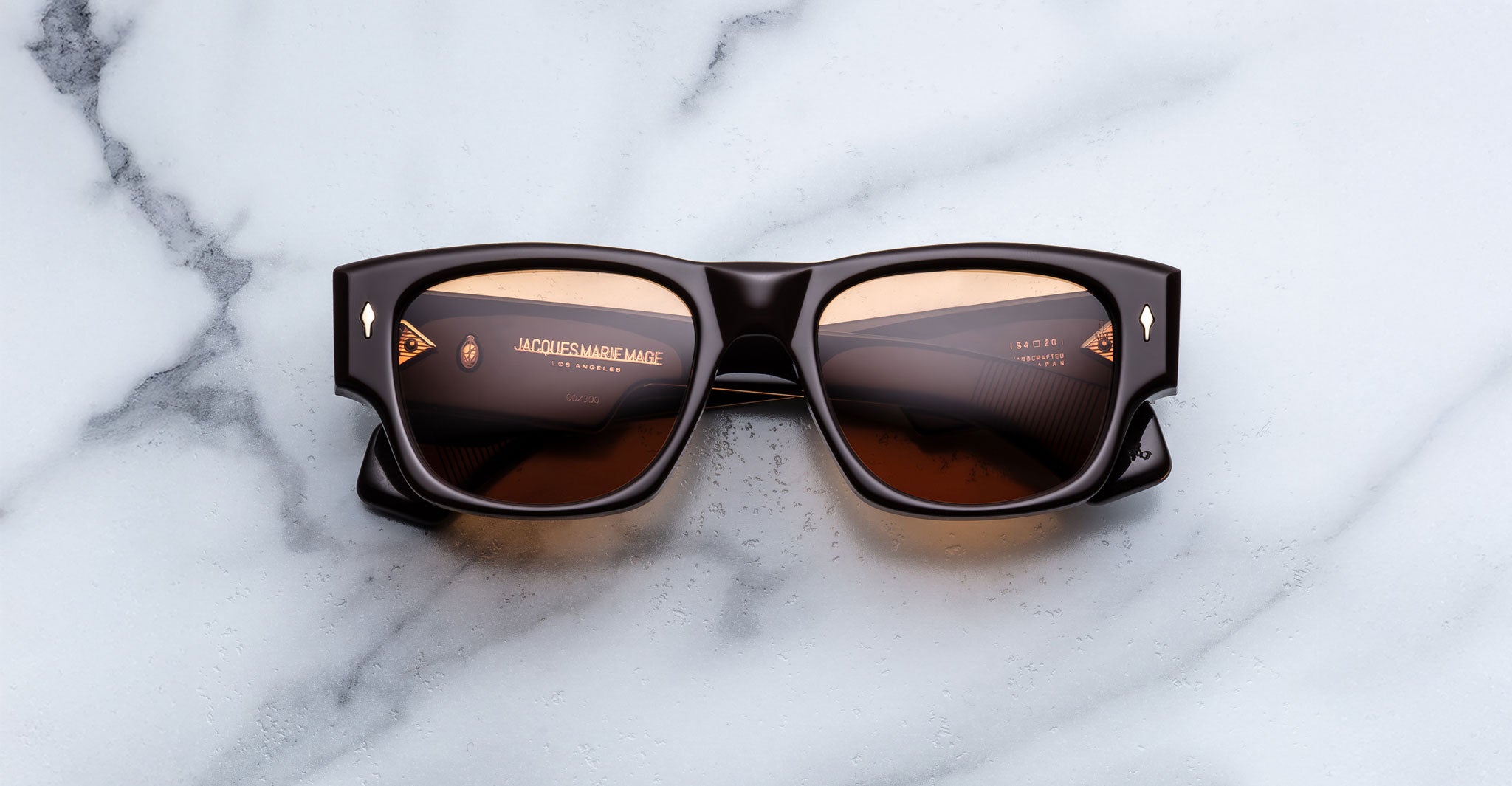 Jacques Marie Mage Dino in Walnut brown acetate sunglass frame with brown lenses, gold arrowhead pins, and sculptural wide temples, front view