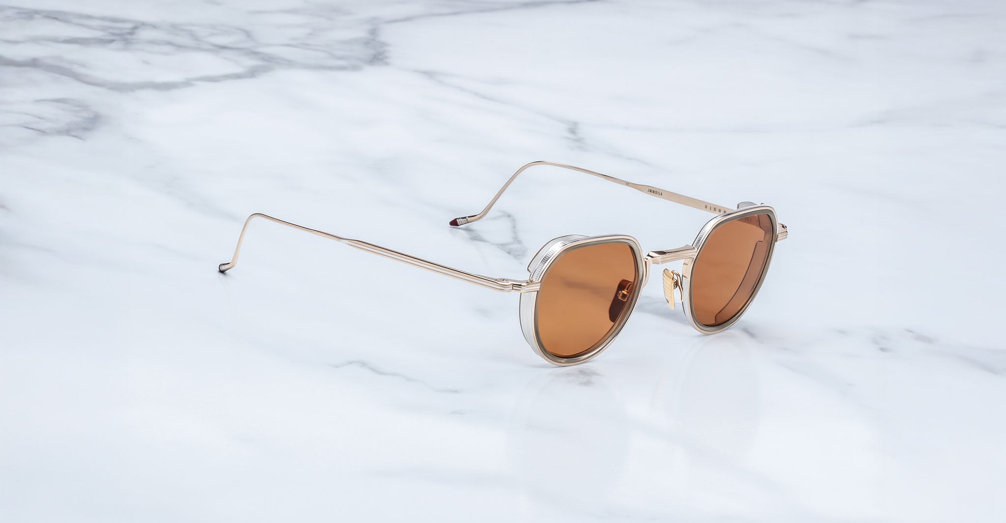Jacques Marie Mage Dixon gold sunglasses with brown lenses, viewed from above, showing retro frame design.
