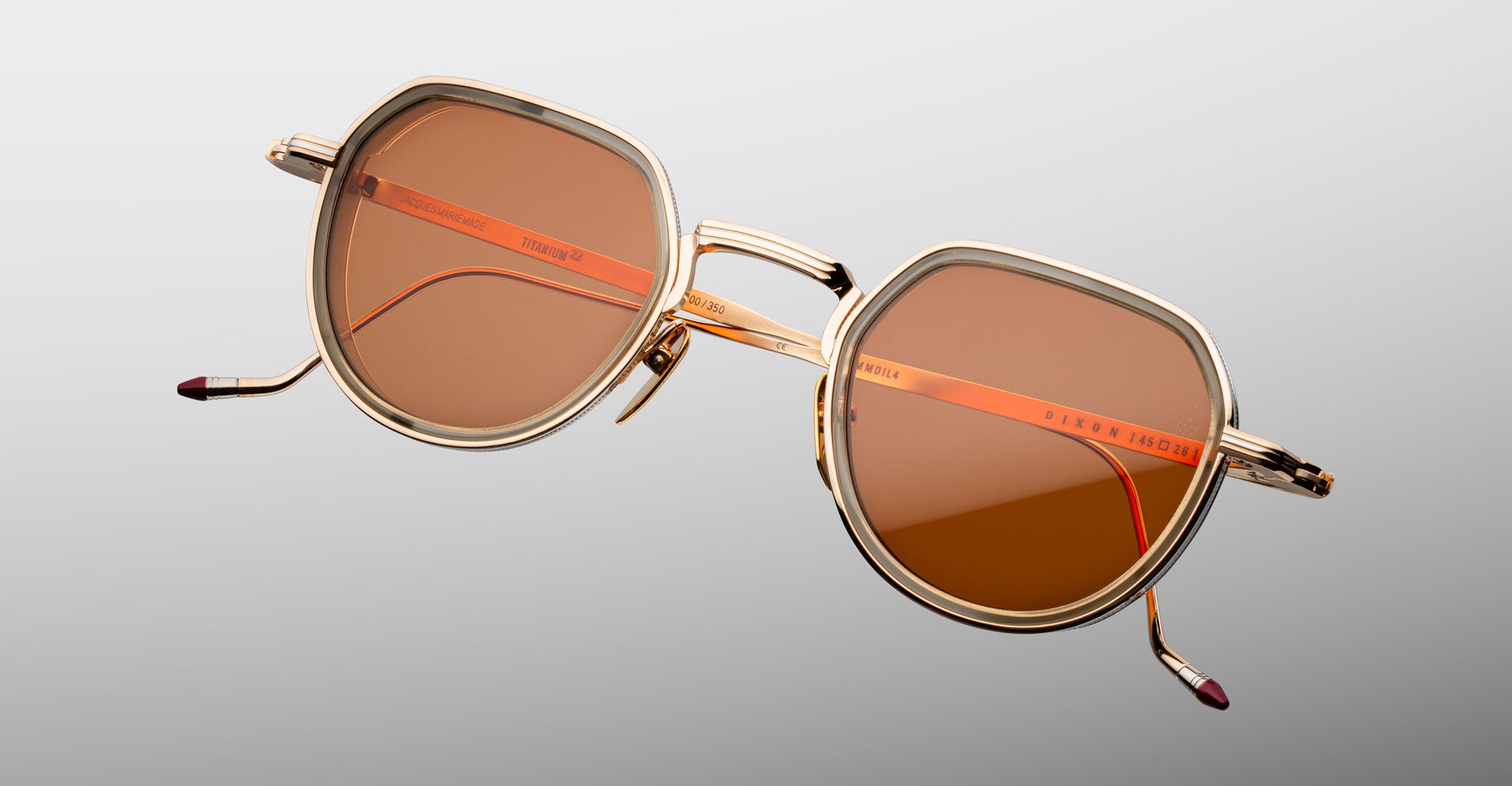 Jacques Marie Mage Dixon sunglasses, gold frame with brown lenses and orange accents, classic style, front angle.