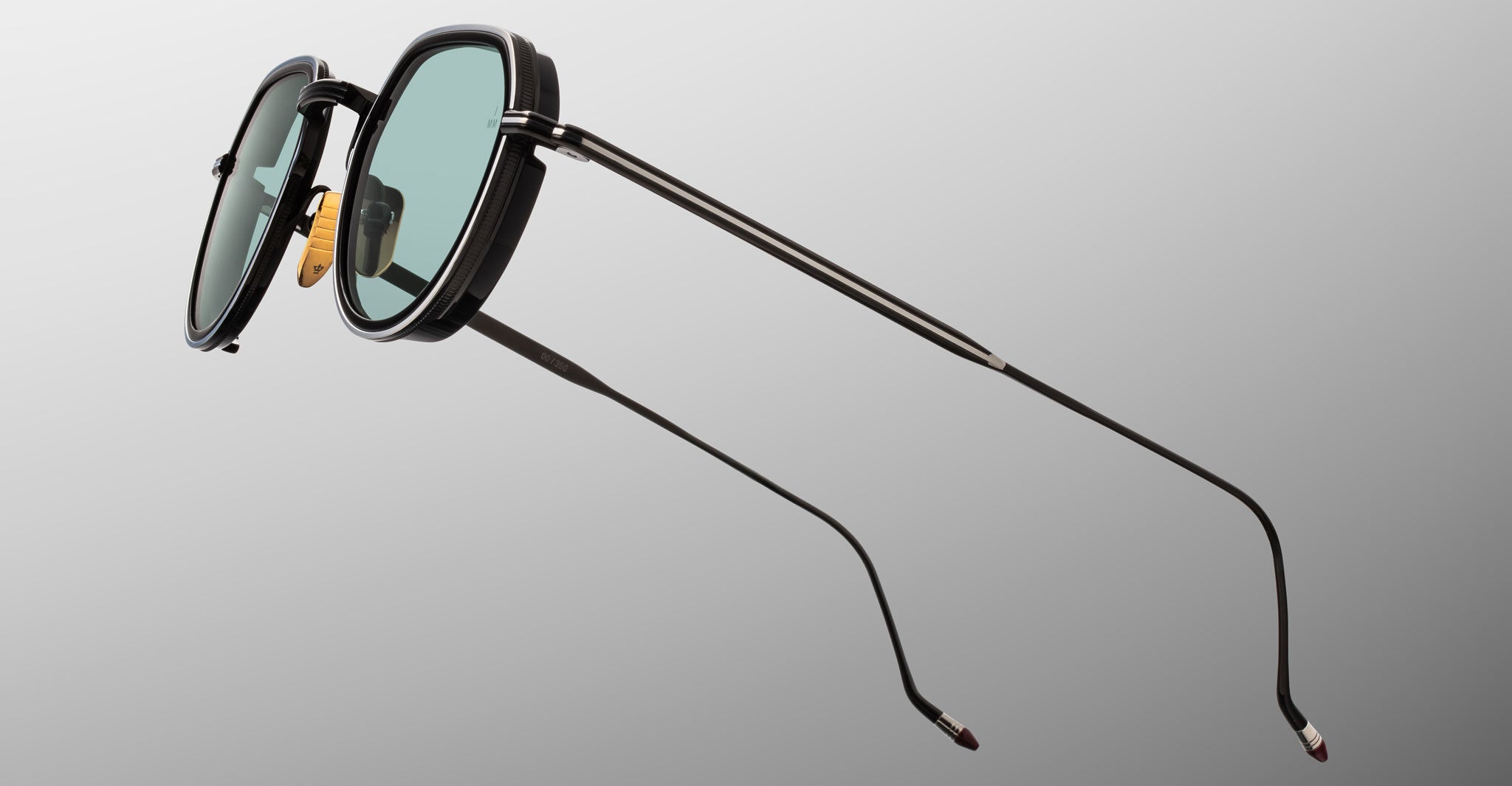 Jacques Marie Mage Dixon sunglasses, black metal rims, green lenses, thin temples, front angle view.