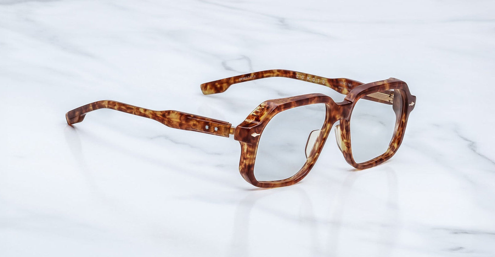 Angled view of the Jacques Marie Mage Domoto eyeglasses in tortoise featuring star-shaped rivets on the temples